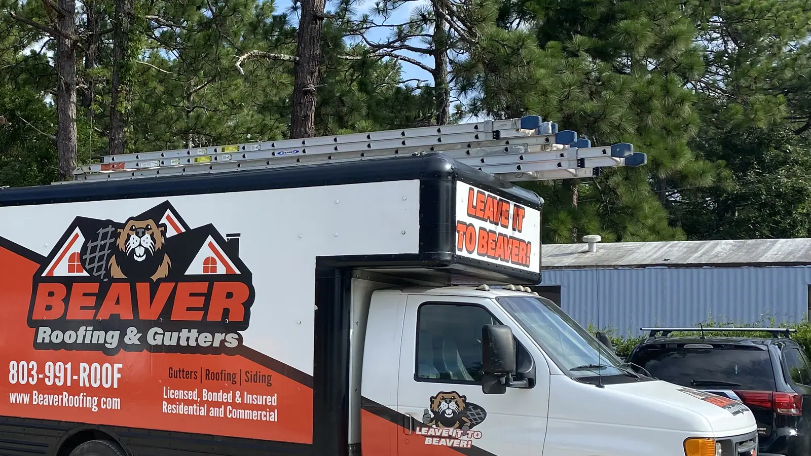 Beaver Roofing branded box truck loaded for a roof replacement job