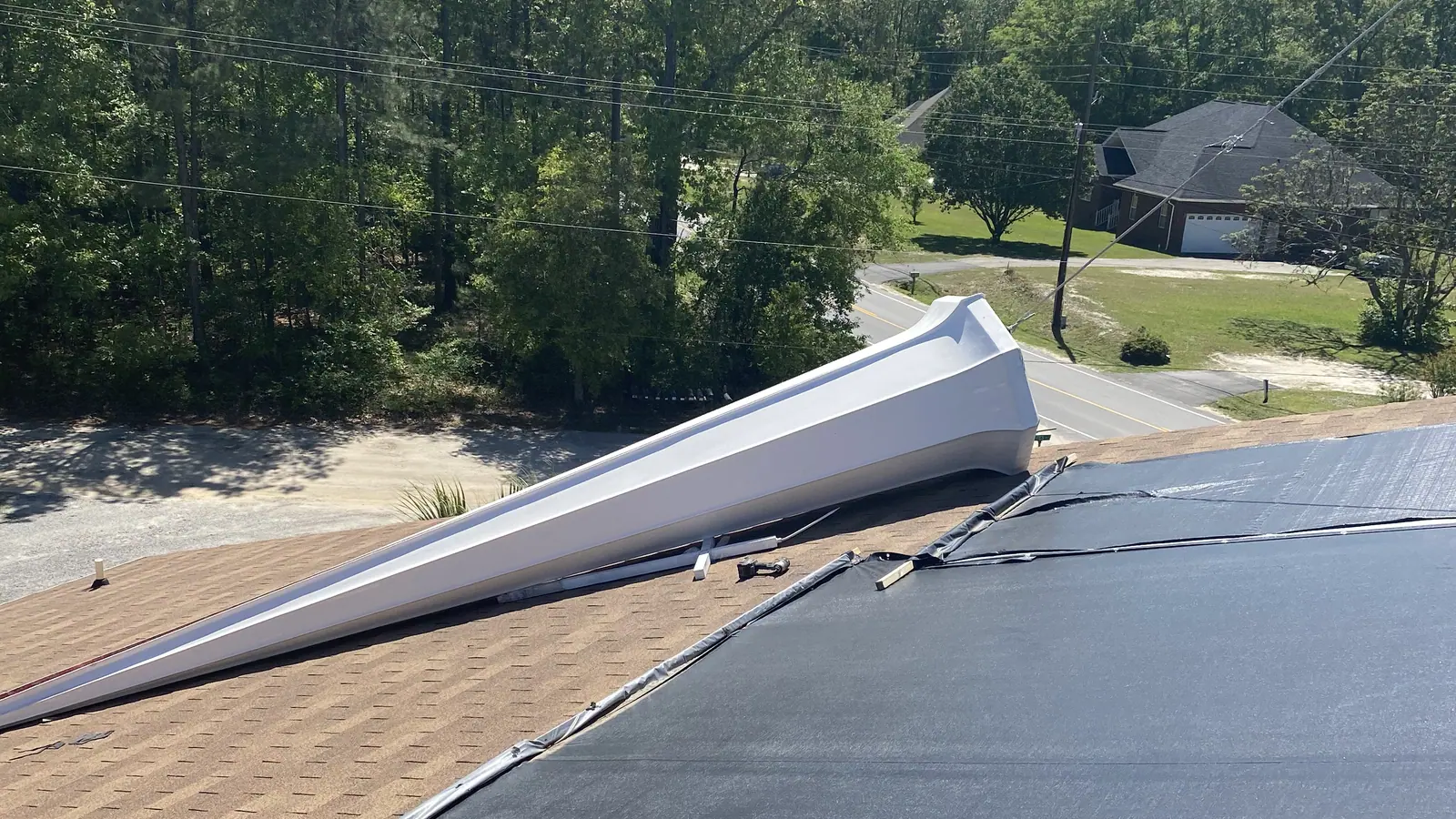 Single-ply membrane being rolled out during a commercial flat roof installation in the South Carolina Midlands