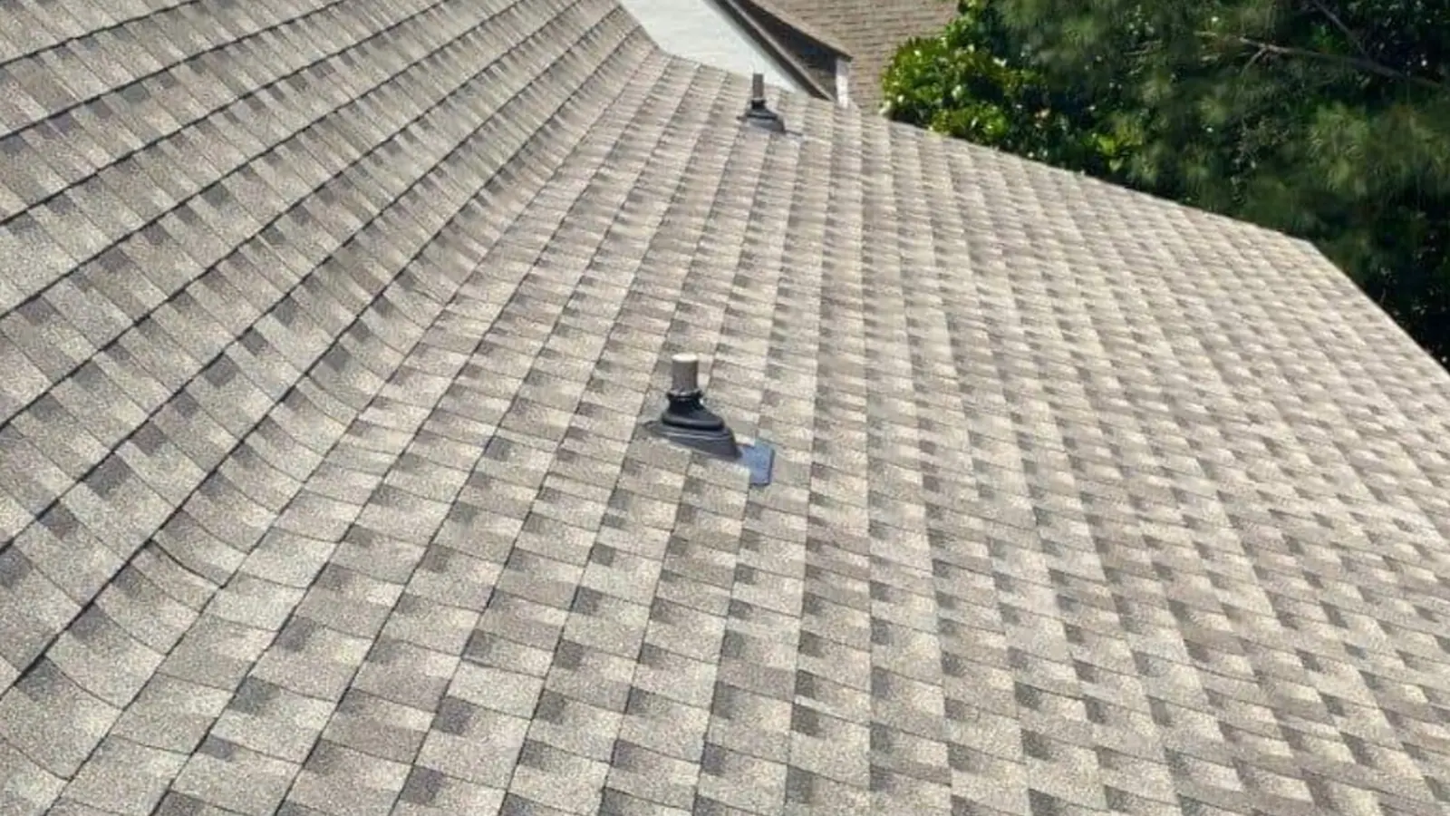 Close-up of a newly installed architectural shingle field running up to the ridge