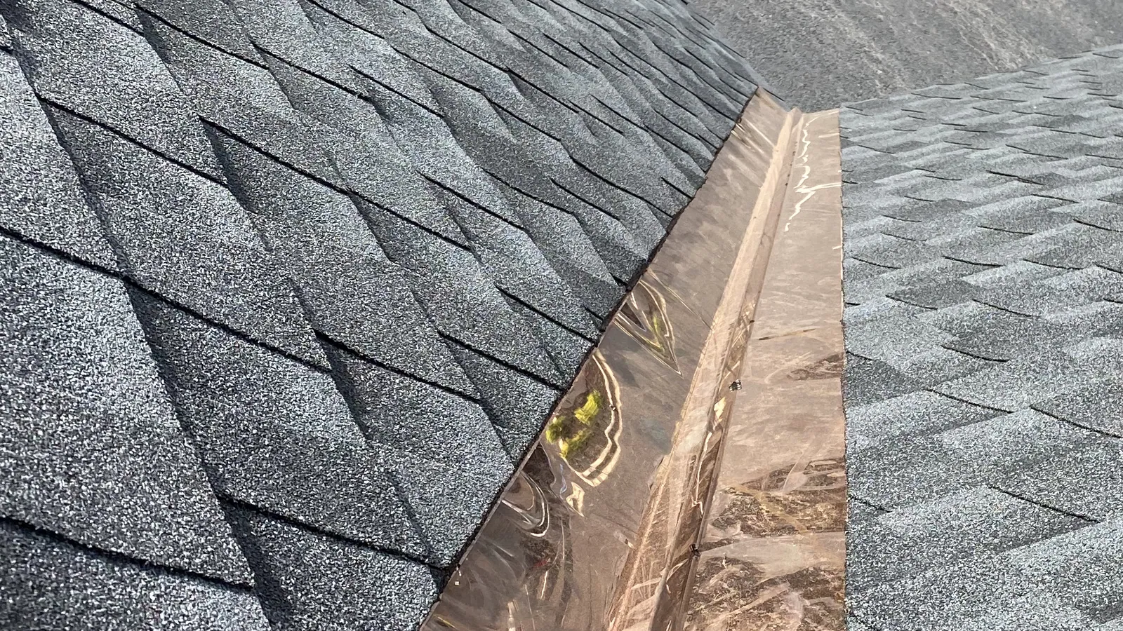 Copper valley pan installed between two architectural shingle slopes